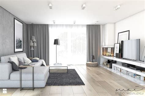 Salon z jasną podłogą i ciemnymi meblami